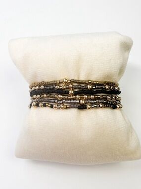 6 ENewton themed black, gold, and silver bracelet stack